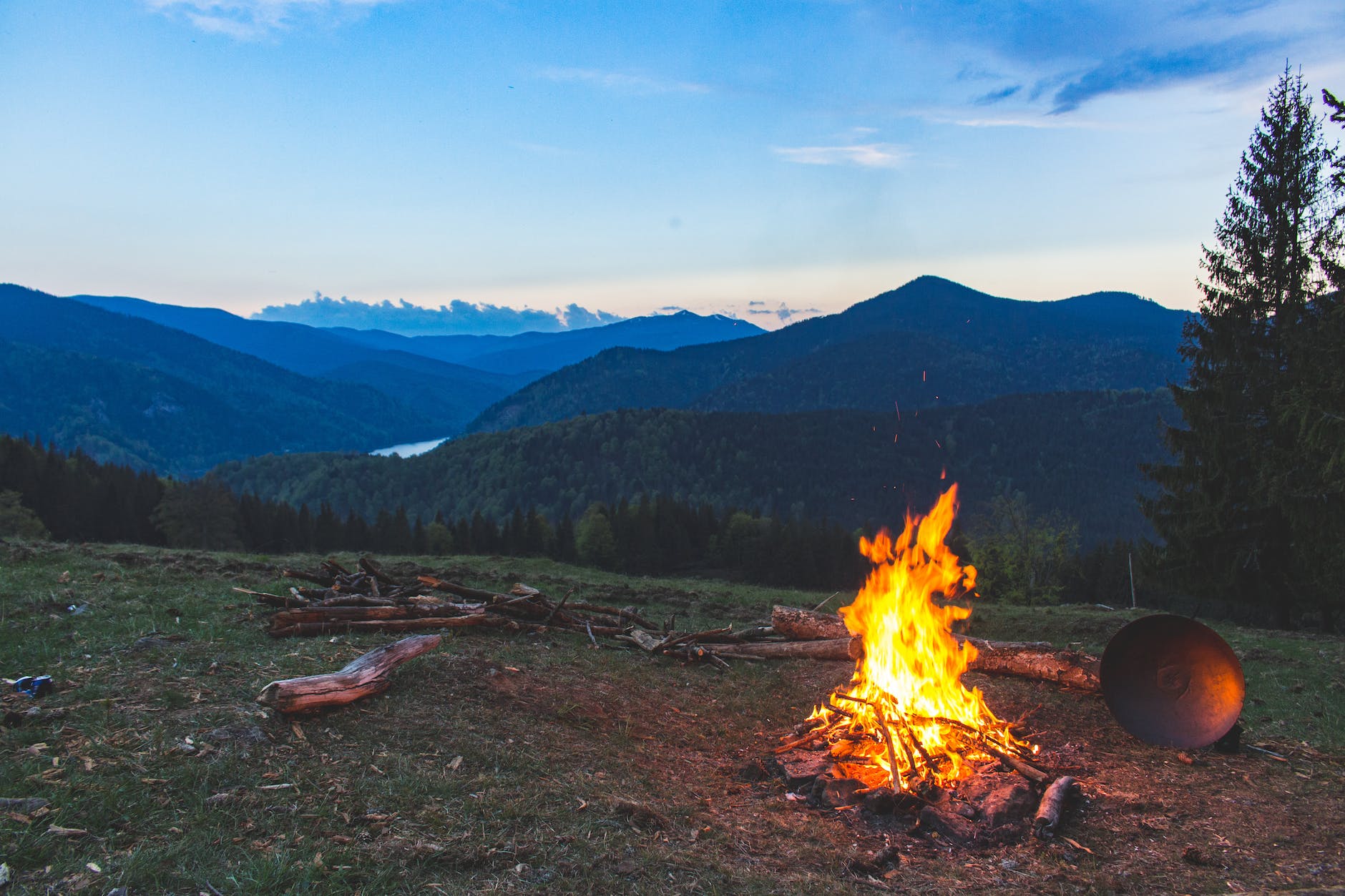 bonfire surrounded with green grass field, considering harvest reflections, tarot spread, first harvest celebration, seasonal self-inquiry, and summer sabbat ritual