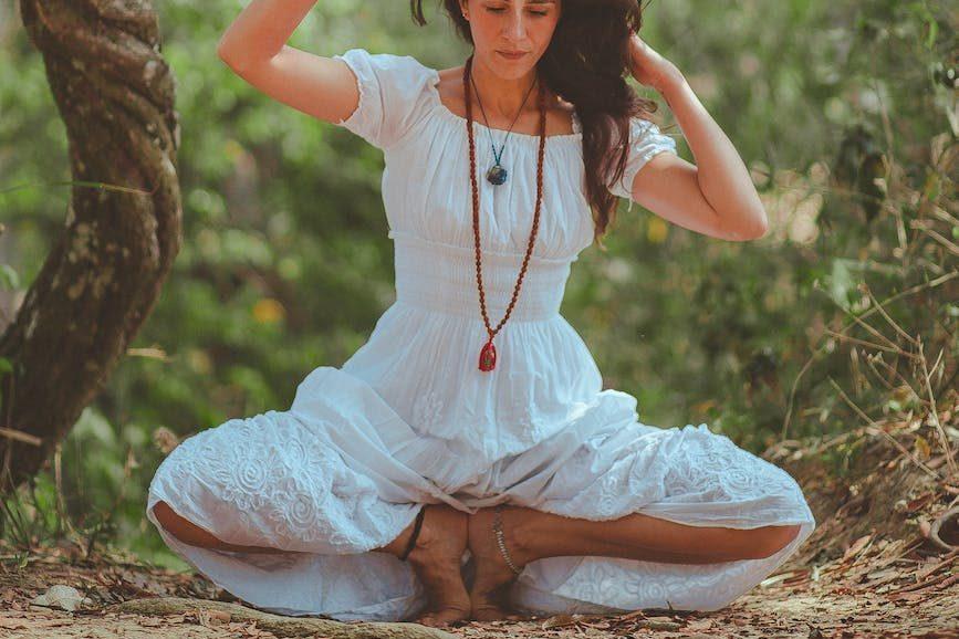 woman doing meditation and yoga in nature 