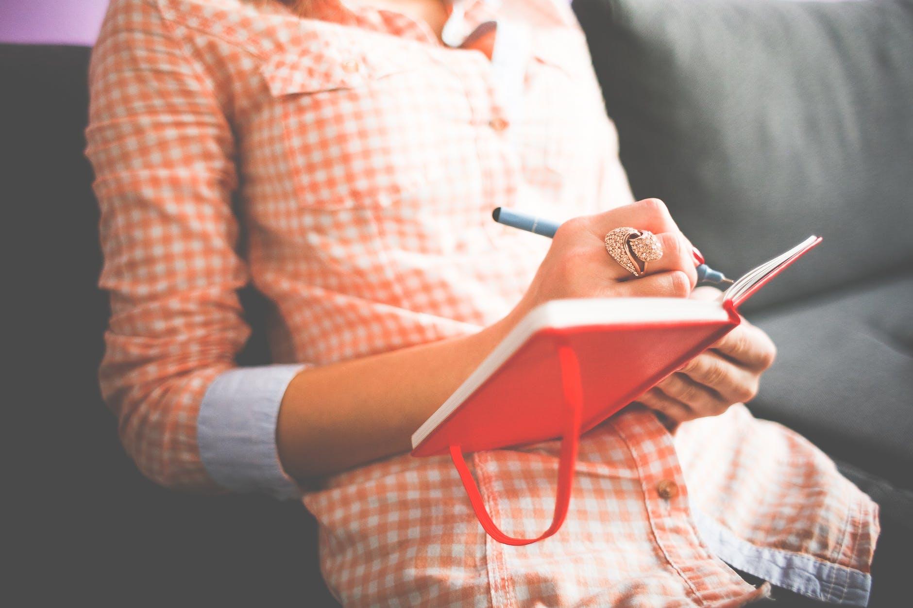 girl writing in a journal for daily mindfulness and personal awareness