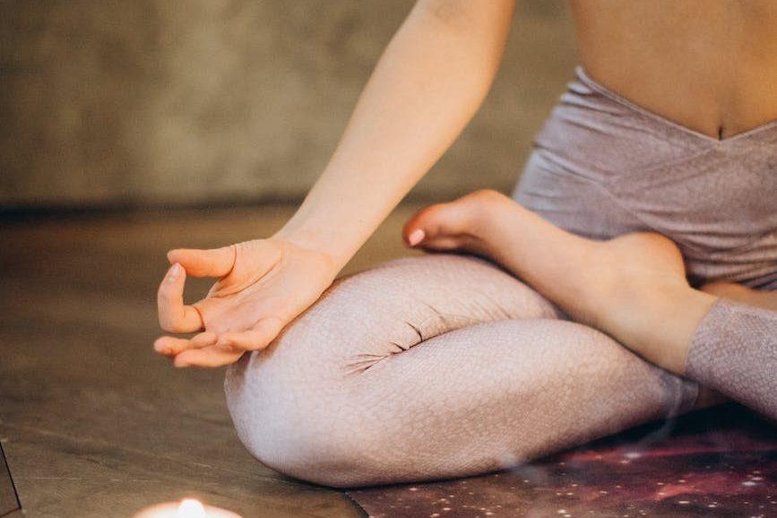 meditating with candles and incense, illustrating mindfulness for wellbeing, awareness, and self-empowerment