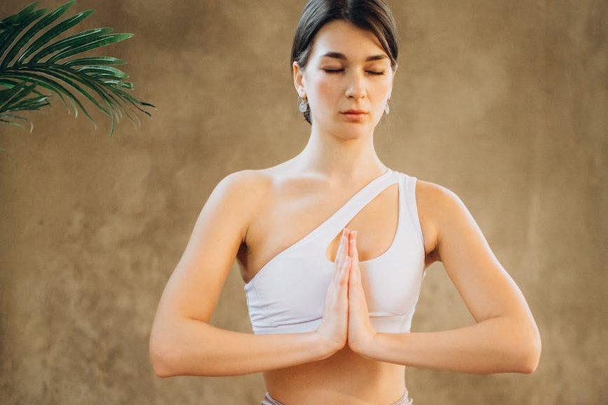 woman practicing yoga, exploring types of meditation and meditation techniques, as well as the benefits of meditation, mindfulness meditation, and how to meditate