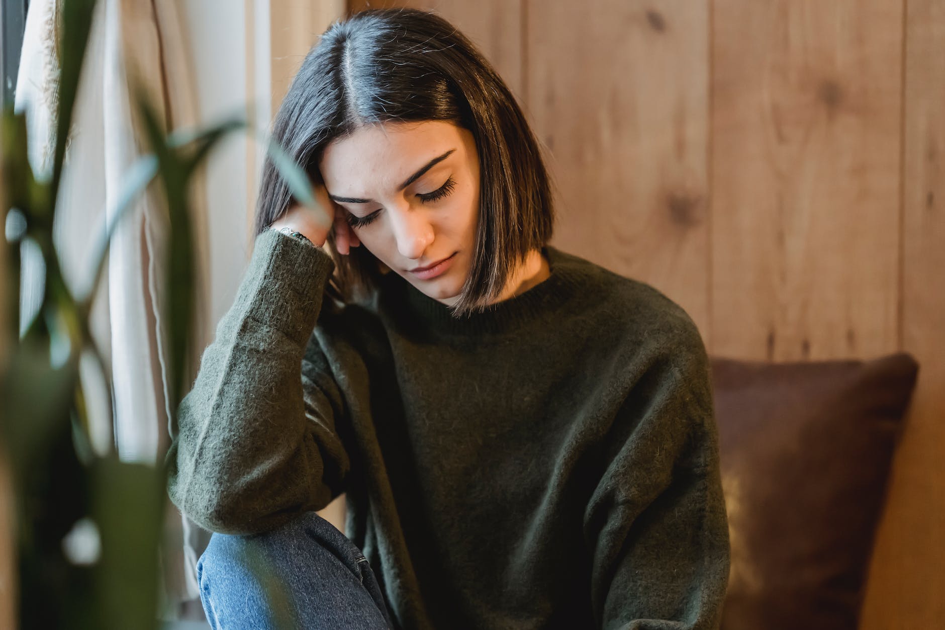 woman having mindfulness break near a window for more awareness and self-empowerment
