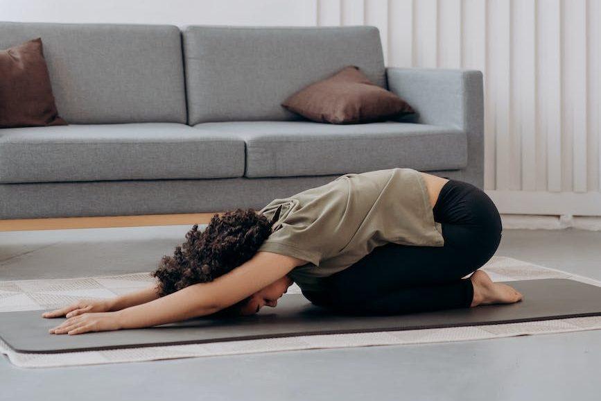 woman in brown shirt in a bending position