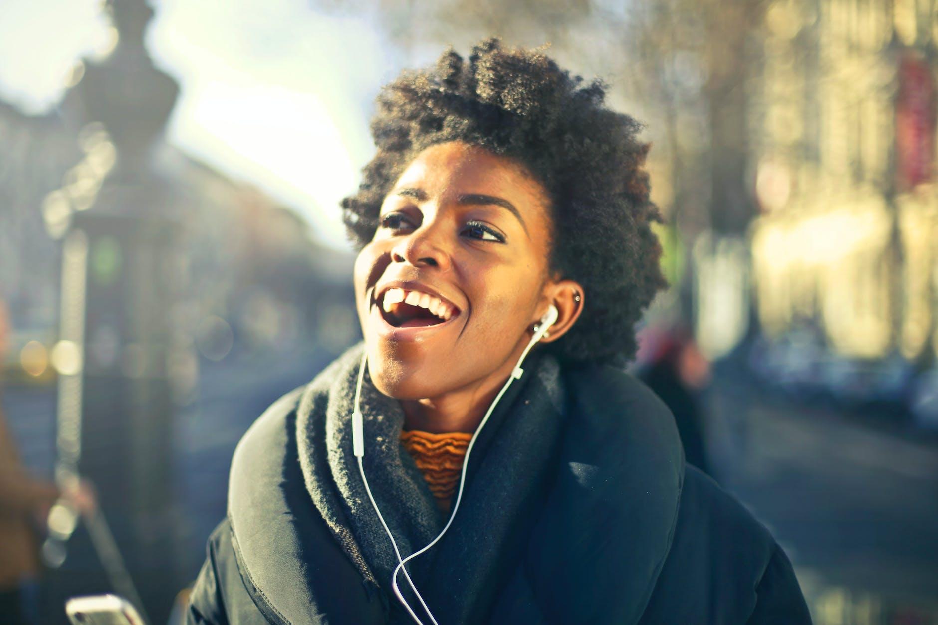 close up photo of a woman listening to music mindfully, illustrating types of meditation and mindfulness techniques