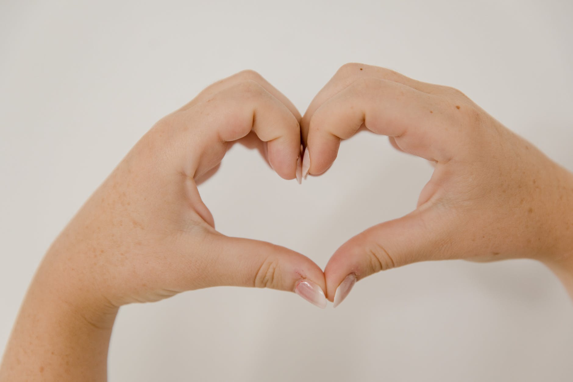 hands showing heart sign, encouraging overcoming meditation hurdles, consistent practice, sustain mindfulness, meditation obstacles, and how to meditate consistently.