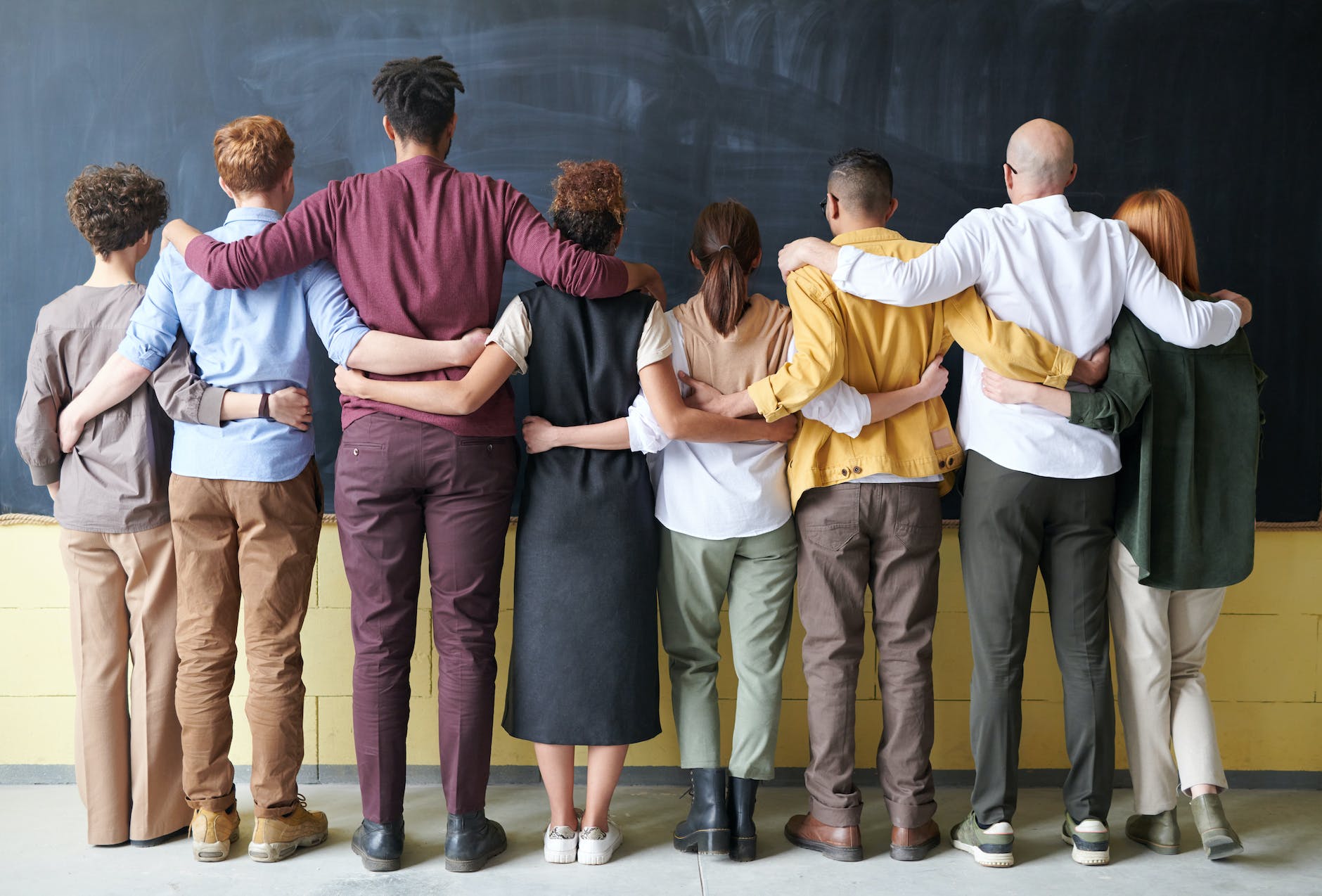 group of people standing indoors, showing the importance of interconnectedness, meditation, oneness, unity and compassion, and connection with nature