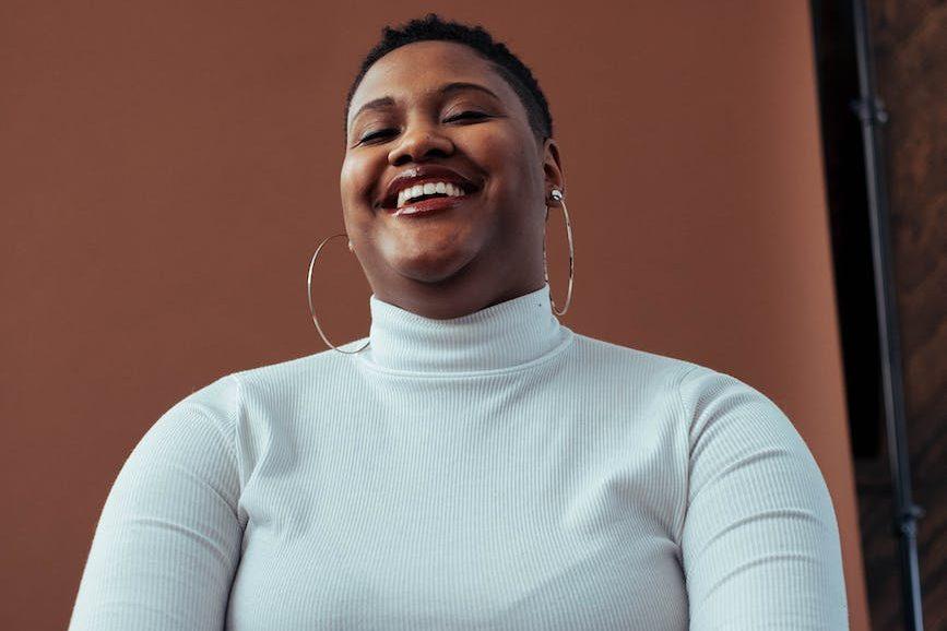 woman wearing white turtleneck sweater, considering meditation hurdles, consistent practice, sustain mindfulness, meditation obstacles, and how to meditate consistently.