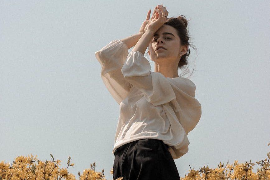 woman in white long sleeve shirt, considering spiritual connection, meditation practice, mindfulness and intuition, connect with higher self, and meditation for inner peace