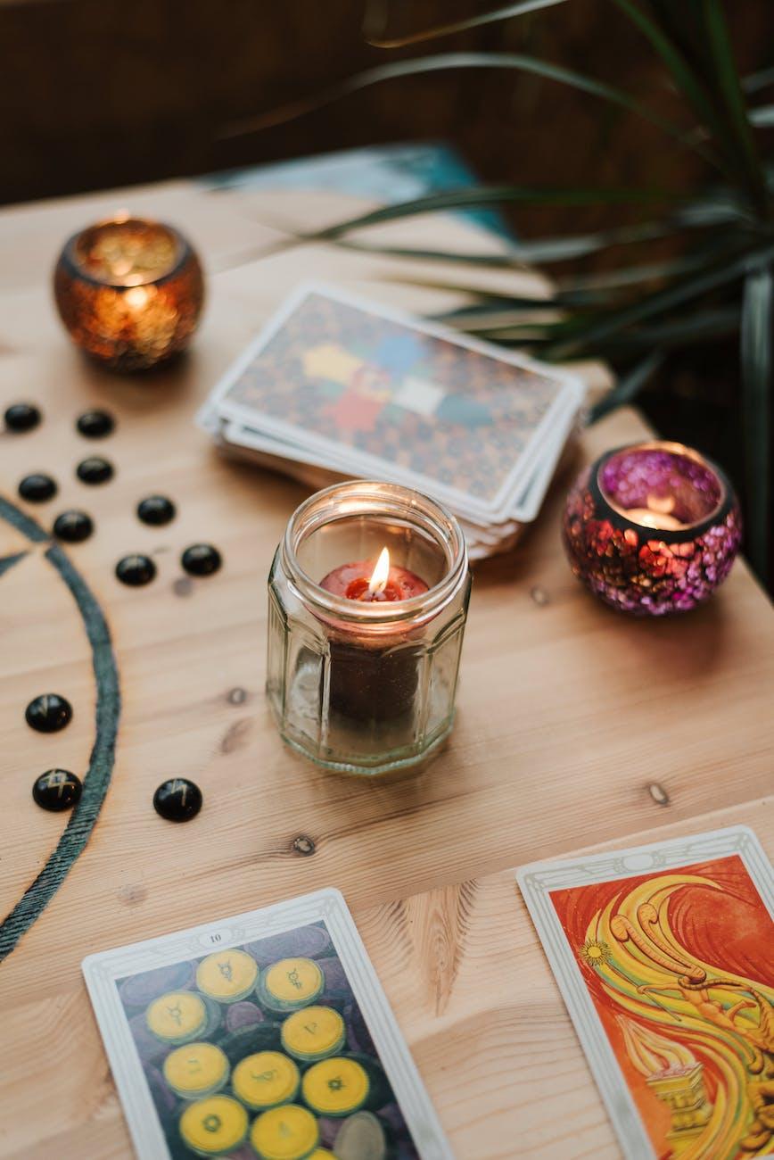 Tarot deck and candles, illustrating Lion’s Gate Portal, Sirius star astrology, Lion's Gate spiritual meaning, manifestation rituals, and Lion's Gate rituals for spiritual transformation