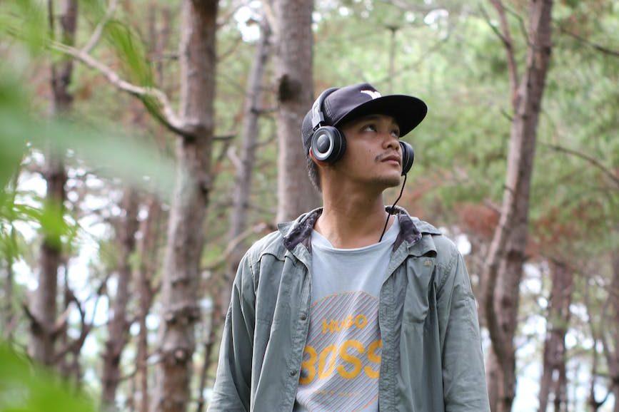man wearing a headphone in the woods