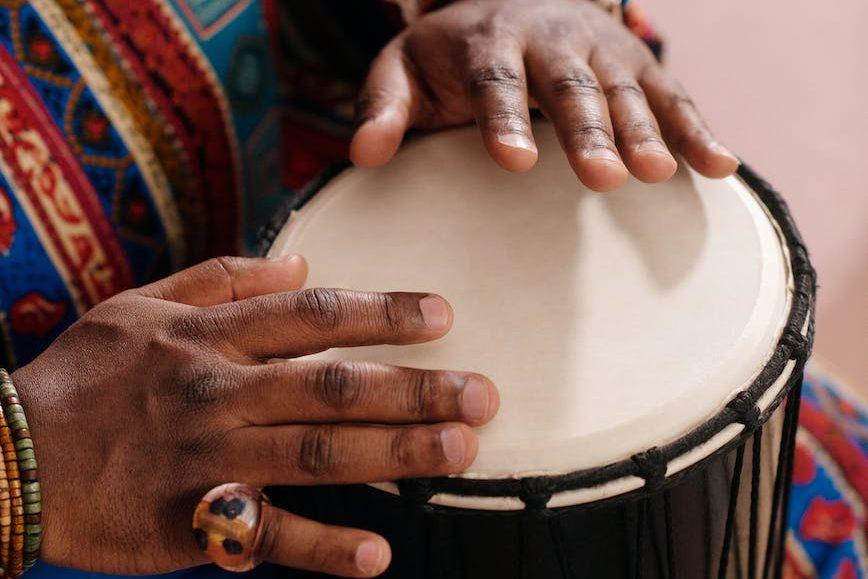 photo of person playing djembe