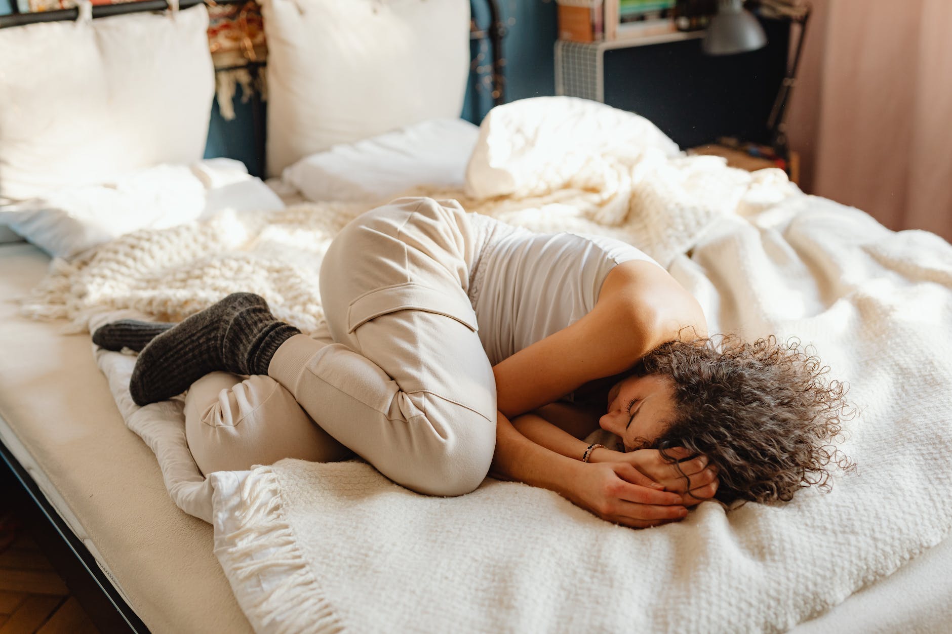 young woman sleeping in fetal position