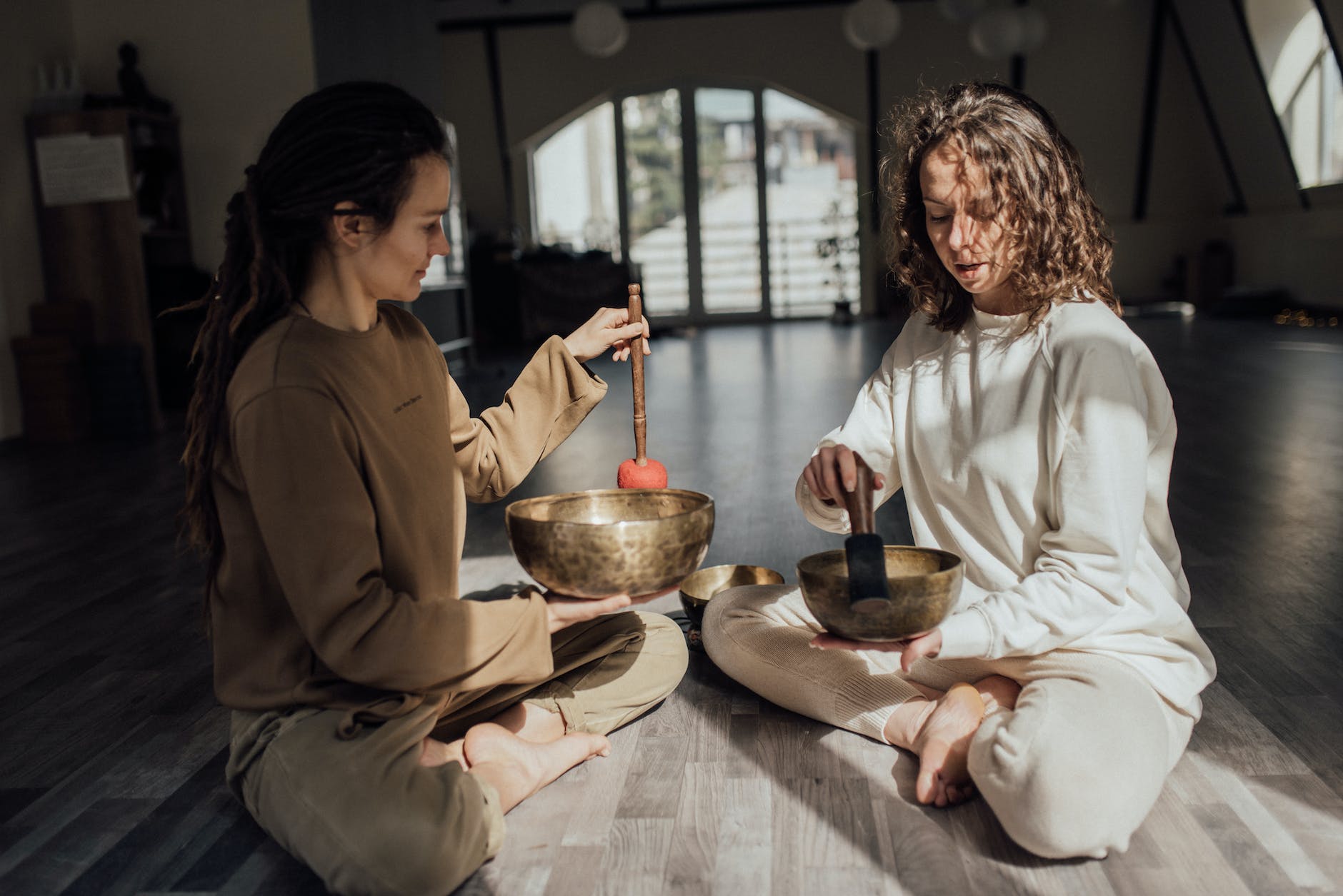 women using singing bowls