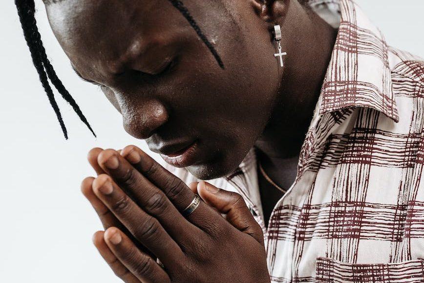 man with eyes closed while praying