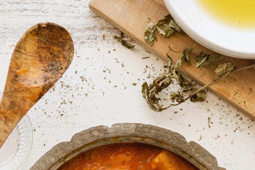 vegetable stew in brown ceramic bowl, illustrating: a feast ritual, sacred eating, Autumn Equinox, harvest celebration, and seasonal food