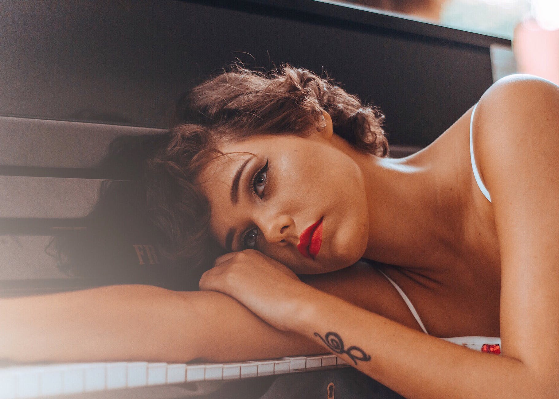 woman leaning on piano