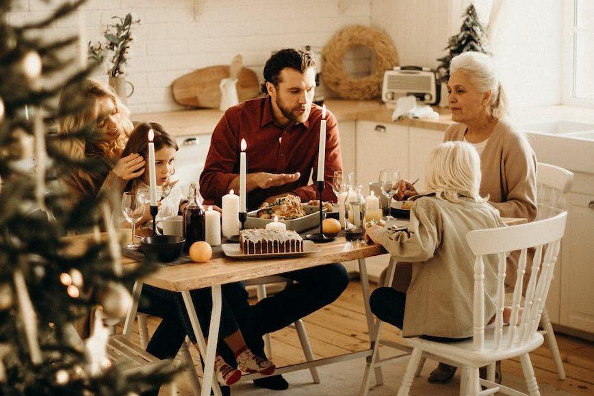 family sitting near dining table and eating food