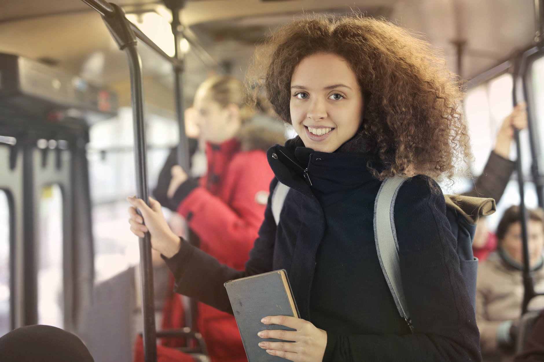 woman in black coat riding subway