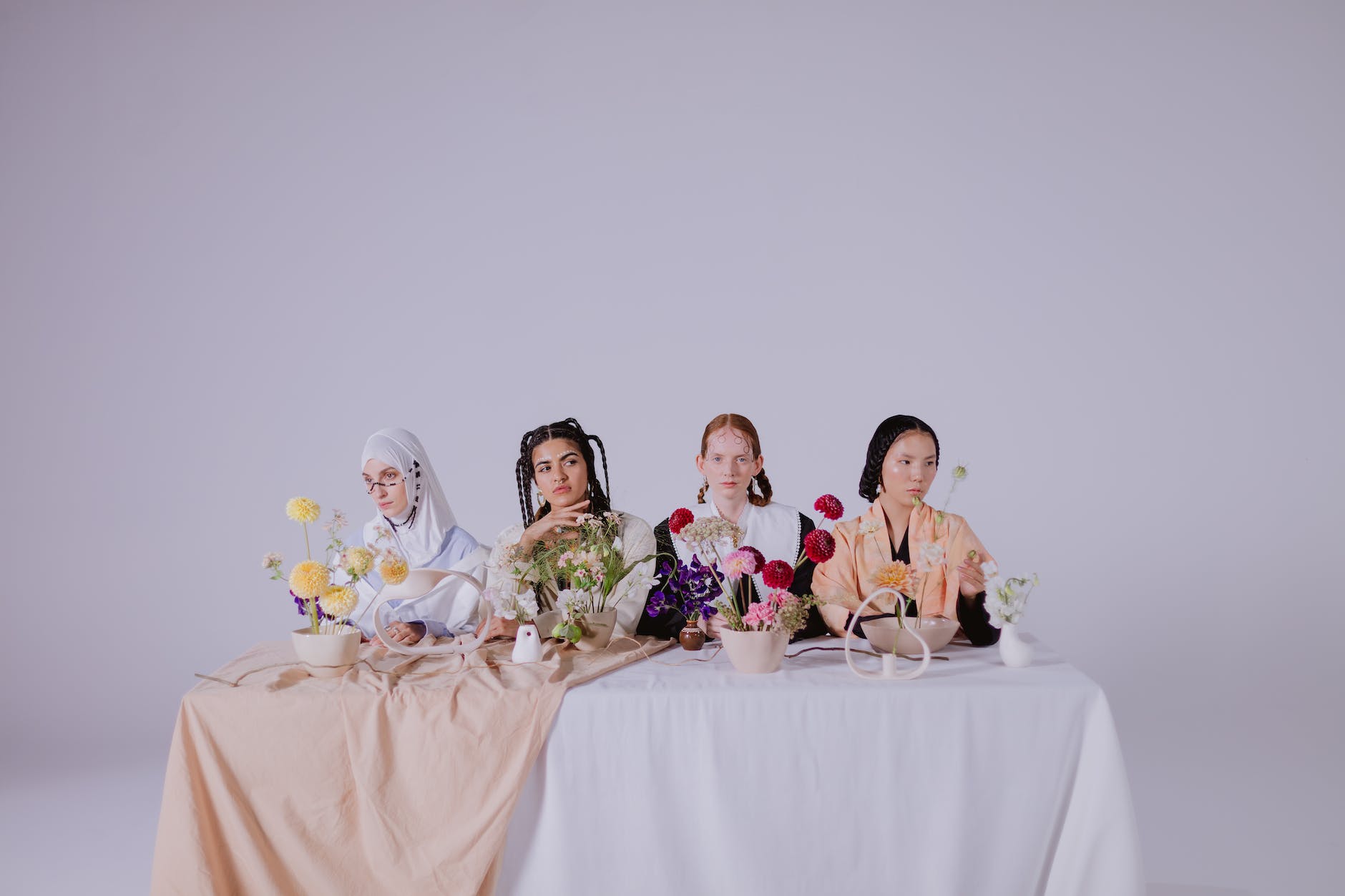 women of different cultures sitting beside each other