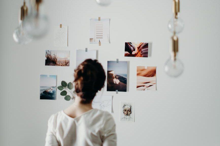 woman wearing white blouse looking on photos