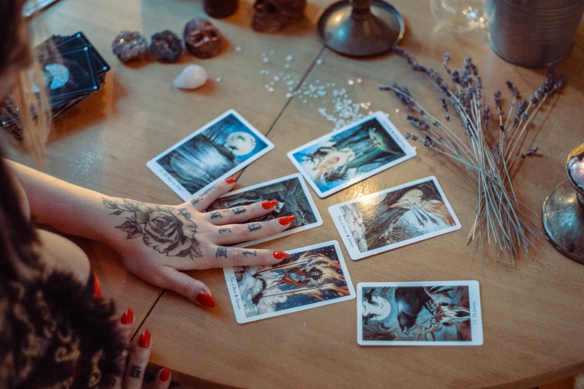 assorted tarot cards on table, illustrating: rare lunar phenomena, eclipse rituals, eclipse meaning, moon spiritual significance, and moon rituals