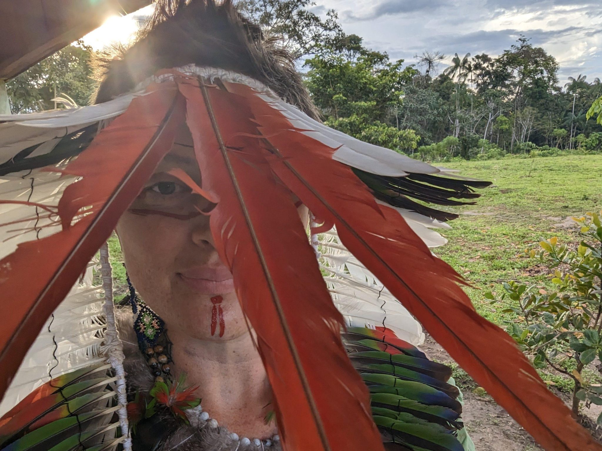 The author, mayryanna, takes a selfie in traditional Huni Kuin adornments in a village in the Amazon rainforest. 