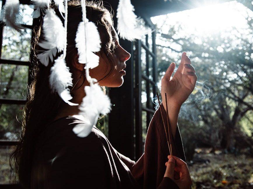 girl in long clothes in shed with shamanic accessories