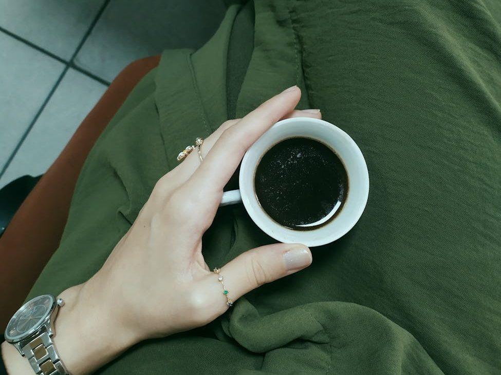 woman hand holding cup of coffee