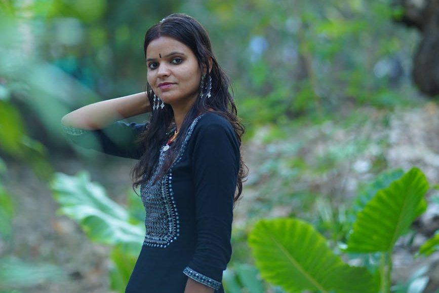 woman wearing traditional clothing walking in a green jungle