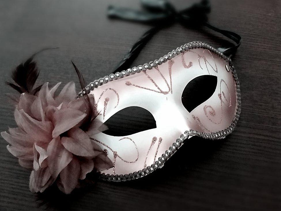 carnival mask decorated with pink flower