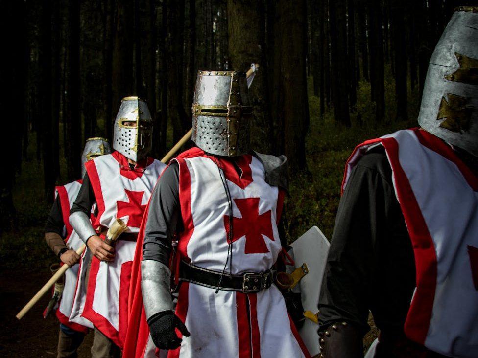 people walking in templar knights armor, evoking: Friday the 13th, Divine Feminine Forgotten Wisdom, Lunar Wisdom, and and Goddesses