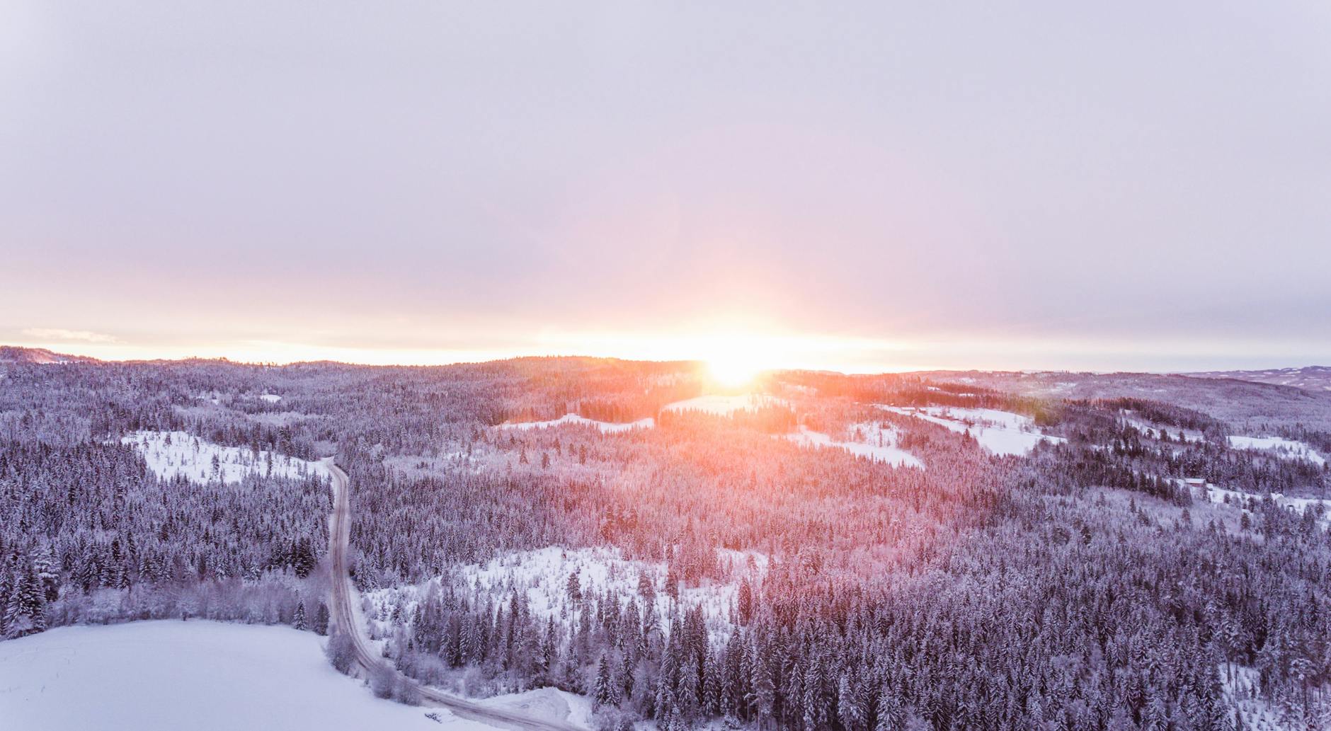 aerial photo of forest in winter, evoking: the Wheel of the Year, seasonal cycles, Sabbats, spiritual growth, and living seasonally