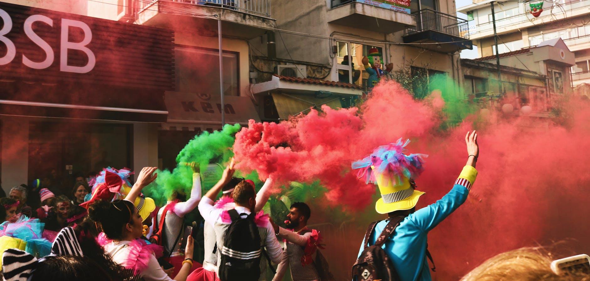 people spraying assorted color of smoke, illustrating: the universally sacred, Wheel of the Year, holy days, global perspective, and seasonal festivals