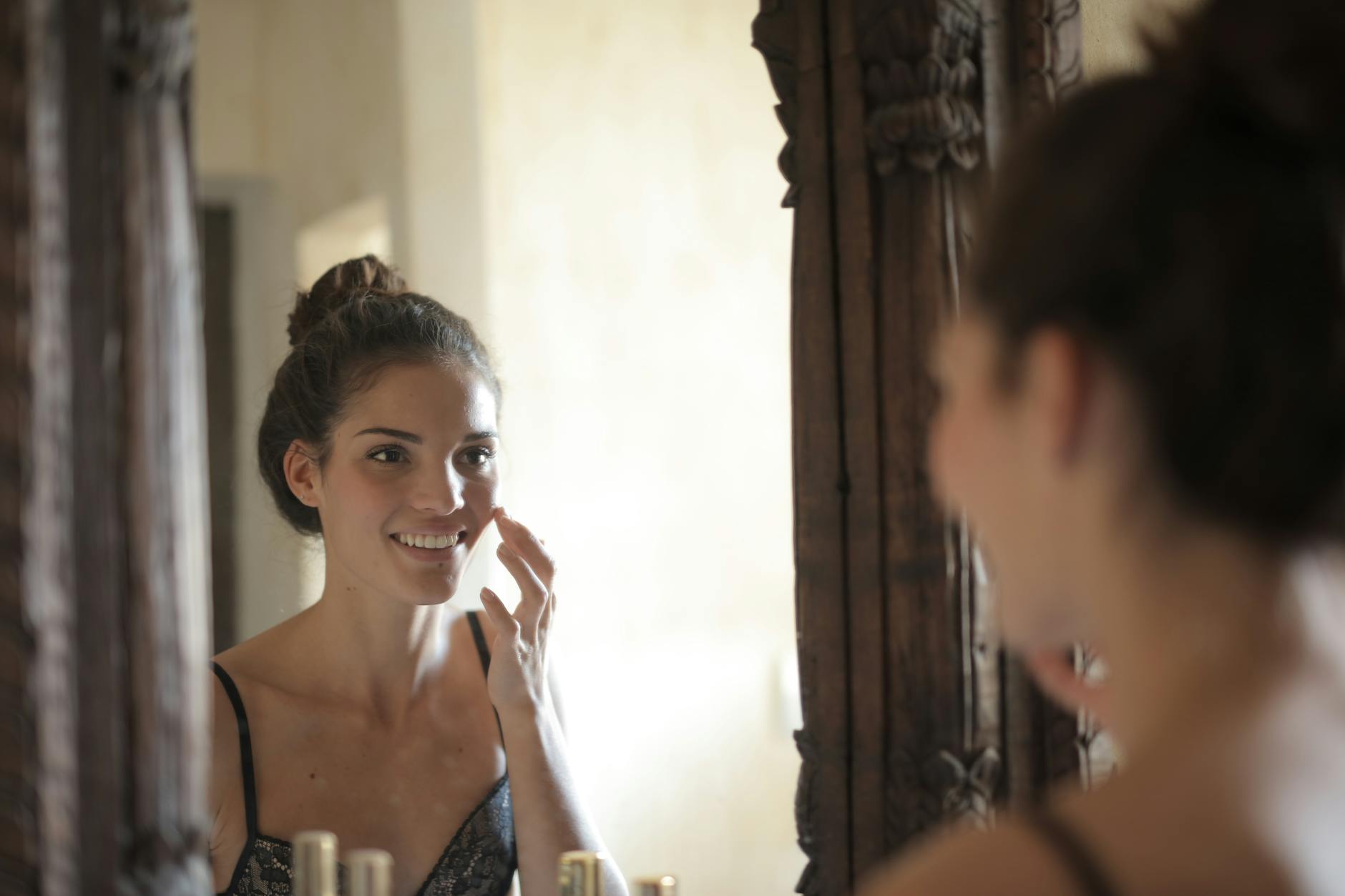 woman touching her cheek, evoking: real manifestation, gratitude, abundance mindset, and intentional living