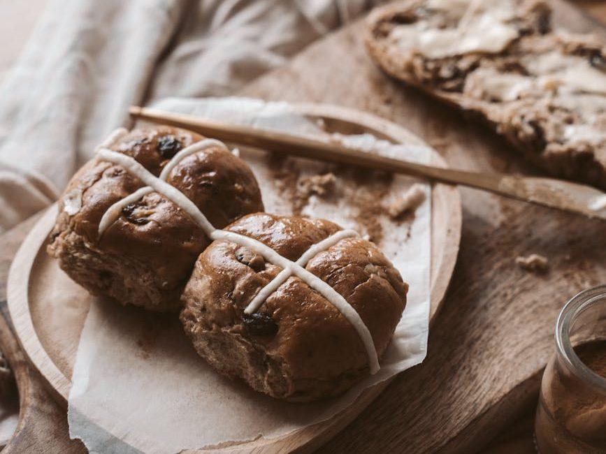 brown bread buns on wooden plate, evoking: Samhain Soul Cakes recipe, soul cakes, Samhain, and ritual baking to honor ancestors