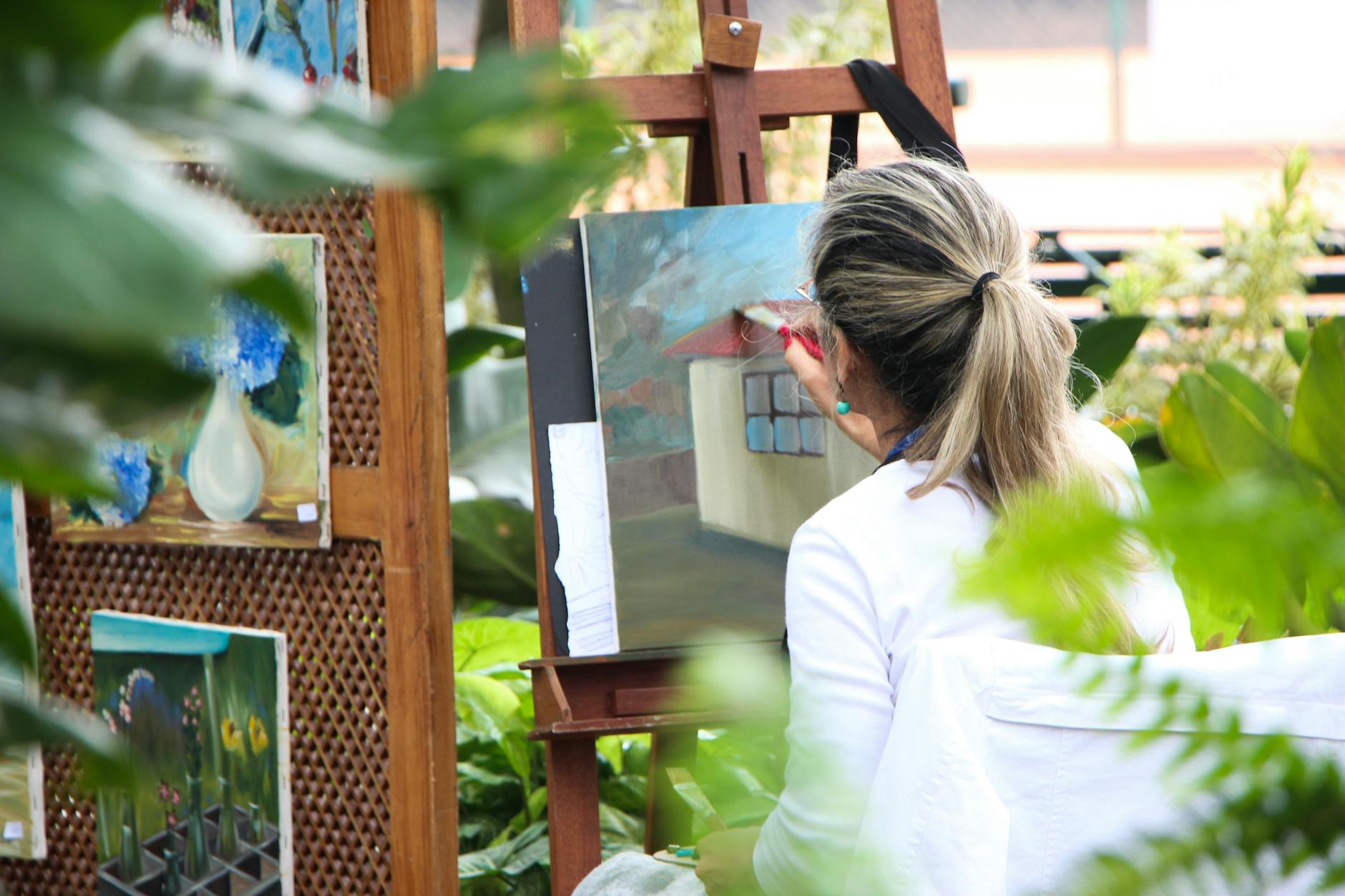 woman painting outside garden, evoking: Year and a Day, Witches' New Year, devotional practice, spiritual commitment, and spiritual growth