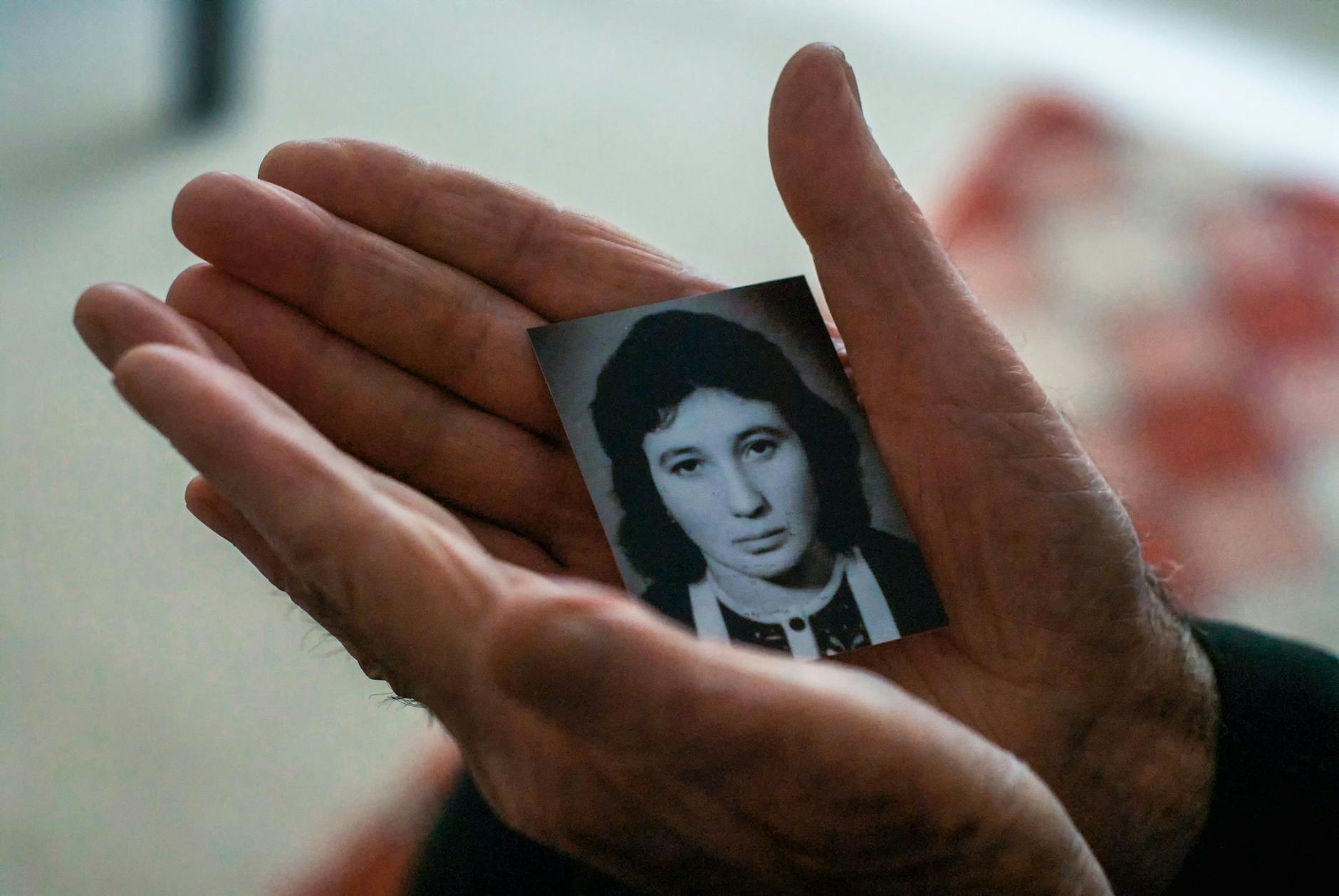 crop elderly man with photo of beloved