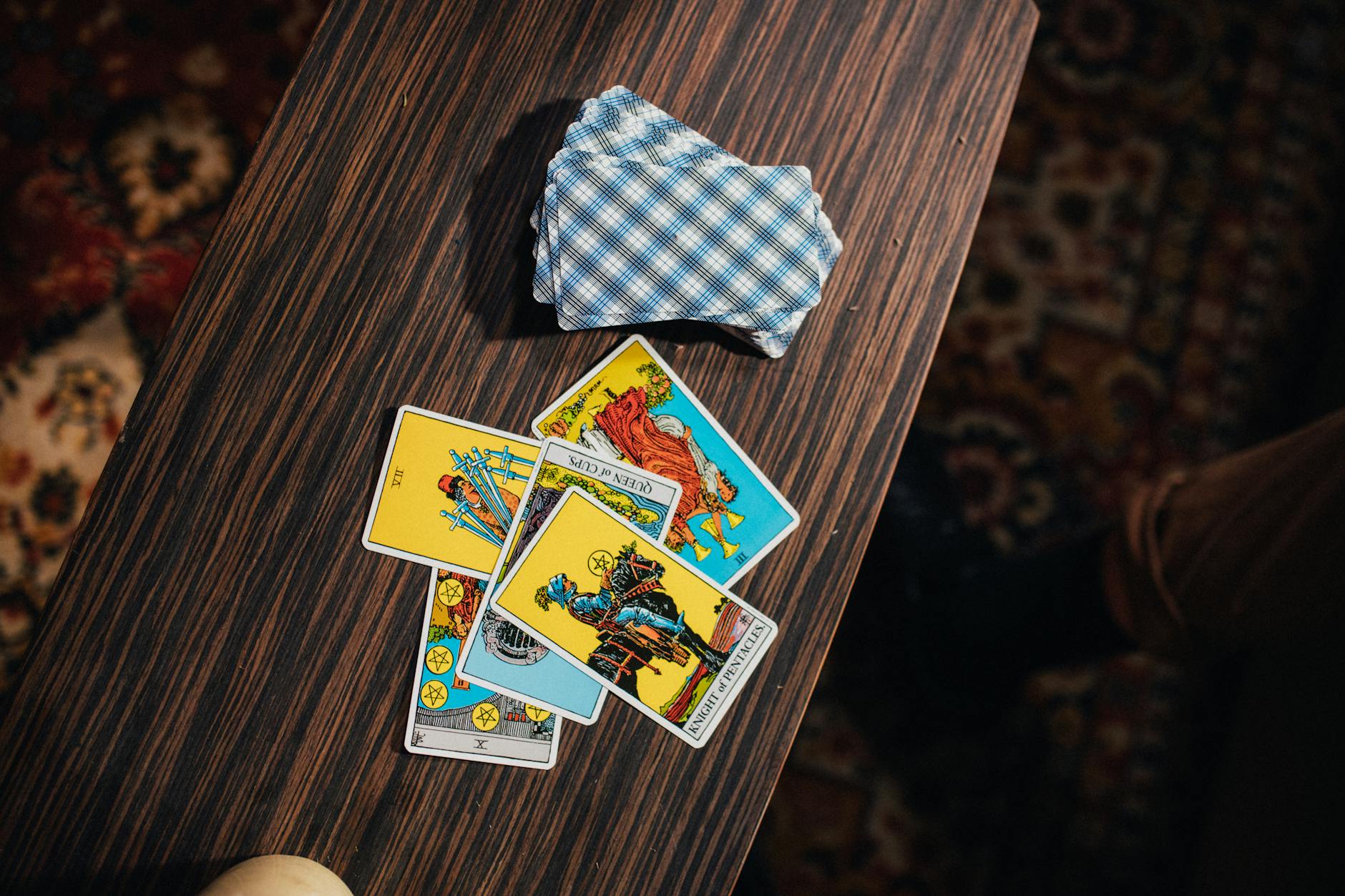 tarot cards on wooden table, evoking: Year and a Day, Witches' New Year, devotional practice, spiritual commitment, and spiritual growth