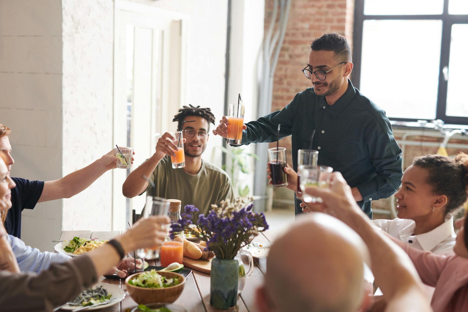 group of friends making toast, illustrating: gratitude, heart-brain coherence, abundance mindset, reciprocity, and wellbeing