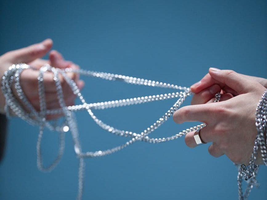 people pulling on chains