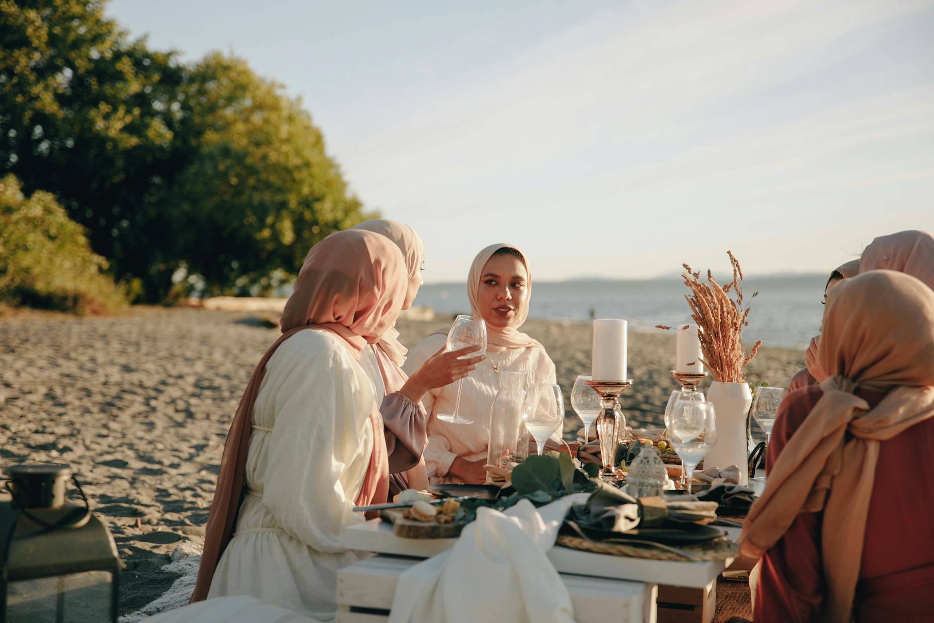 women having picnic in the beach, evoking: Thanksgiving, gratitude, cultural traditions, global, and giving thanks