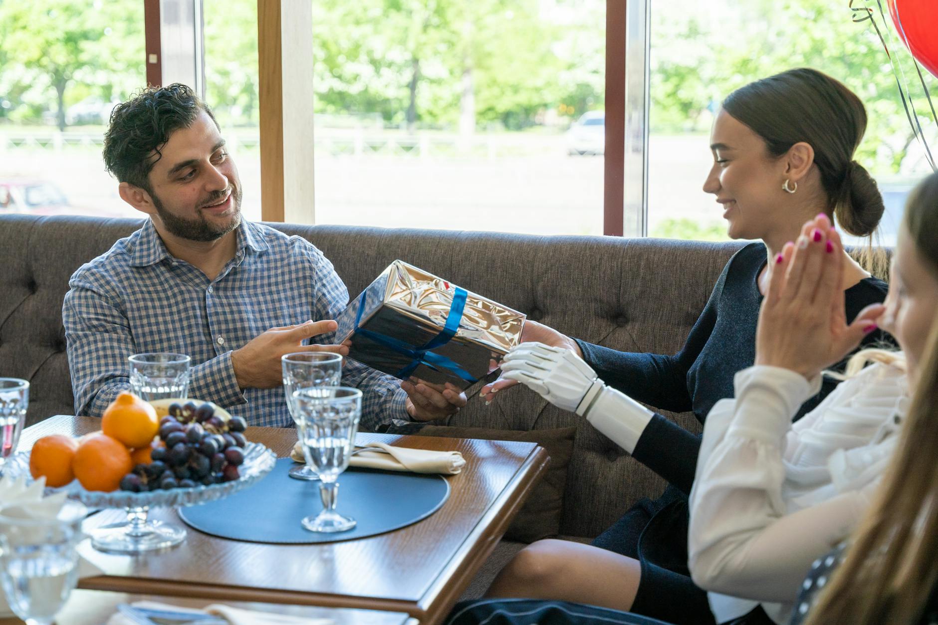 a woman receiving a gift, evoking: Thanksgiving, gratitude, cultural traditions, global, and giving thanks