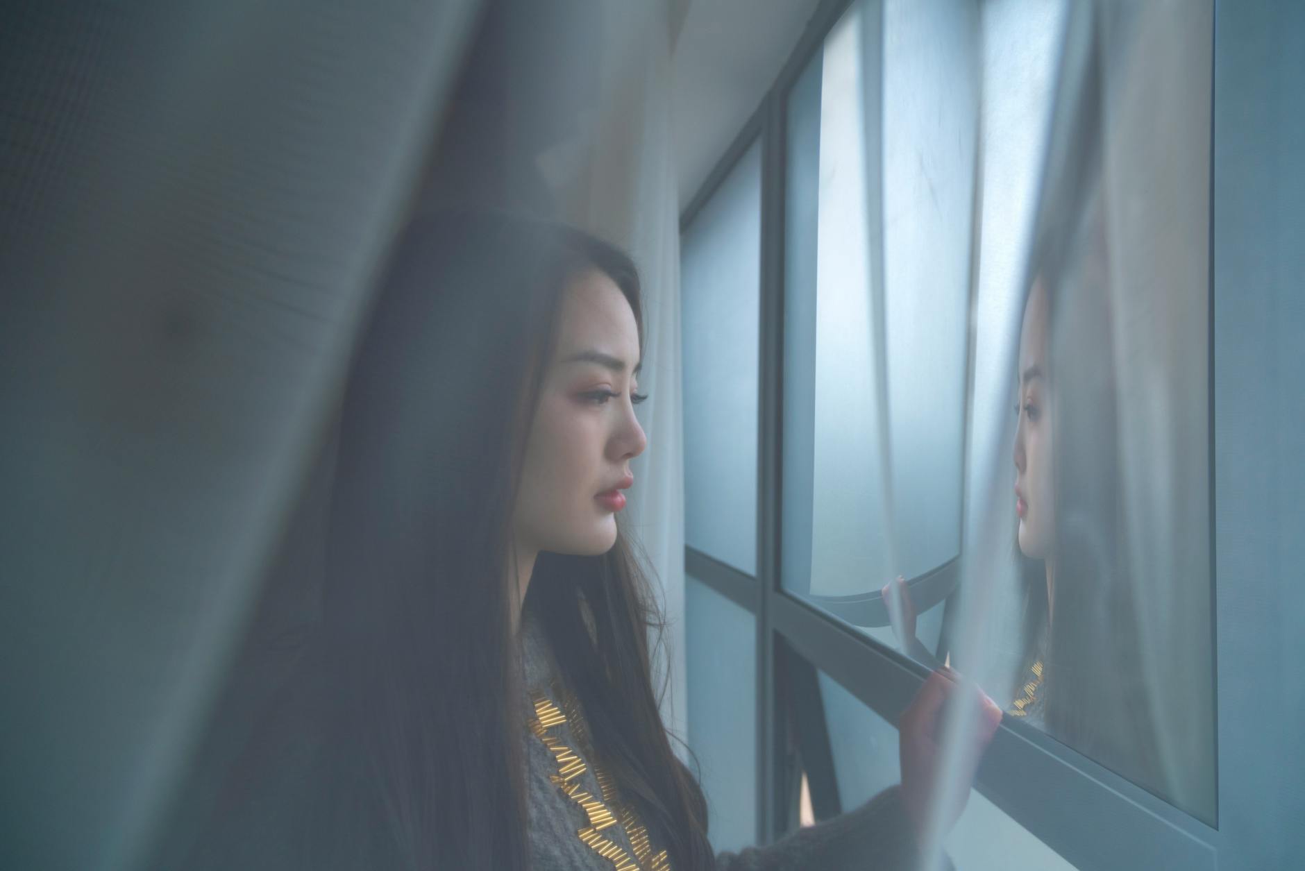woman looking out a window