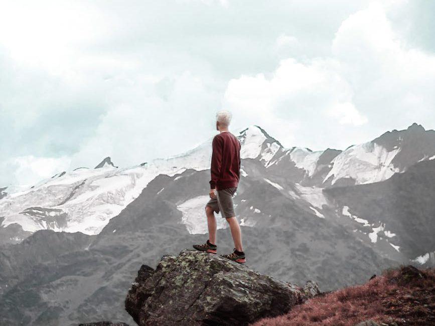 man standing on cliff, evoking: Capricorn, winter solstice, zodiac, astrological sign, and the solar cycle
