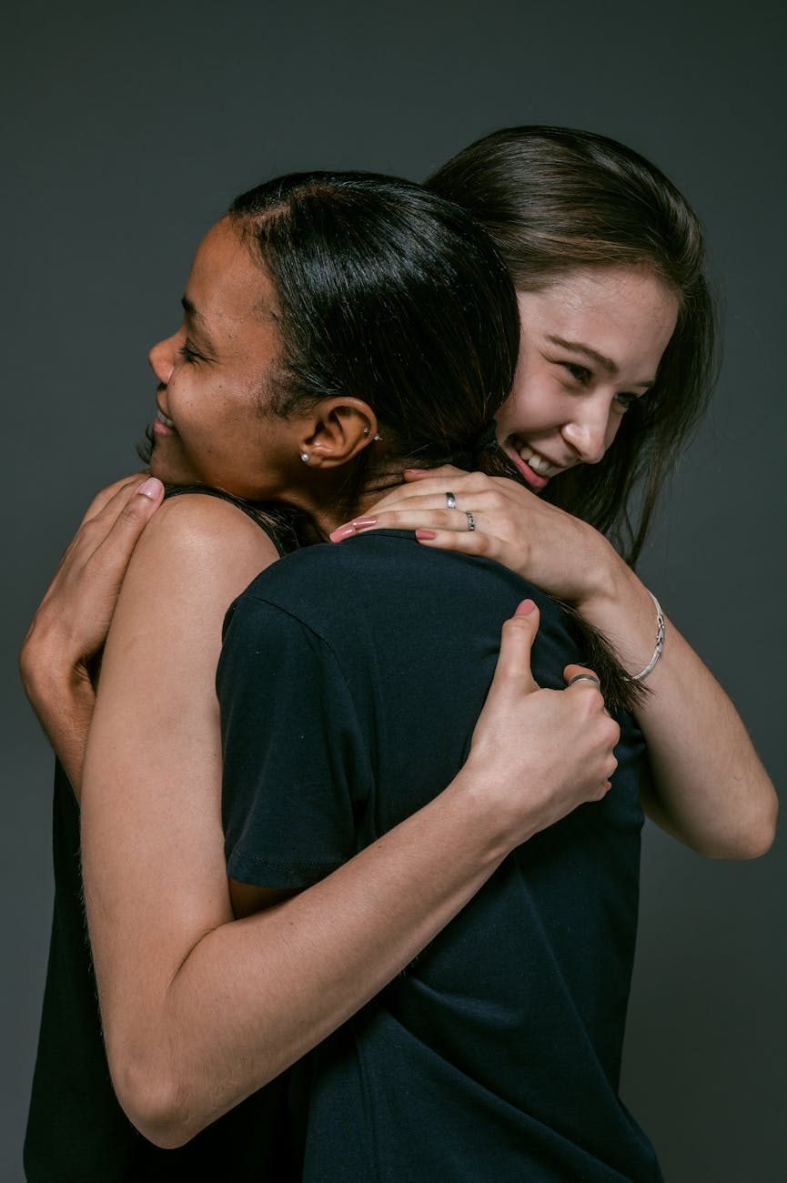 two women happily hugging each other because of their Onesce Insider spiritual growth membership sponsorship