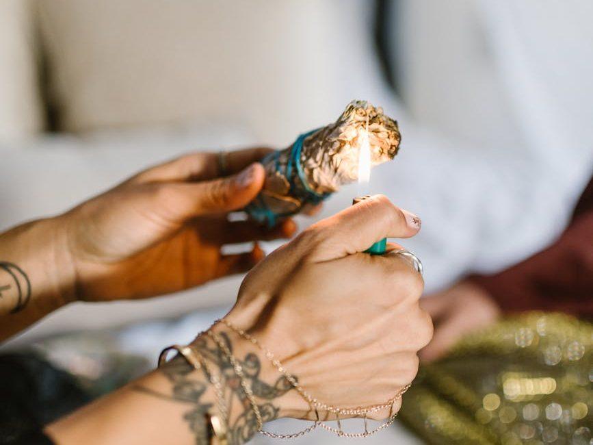 hands burning a sage