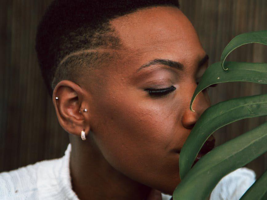 portrait of person with monstera plant, engaging in mindfulness for daily life for holistic wellness