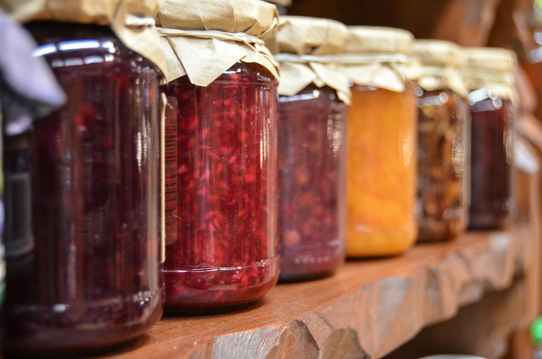 clear glass mason jars filled with fruit spreads for sunflower seed bread 