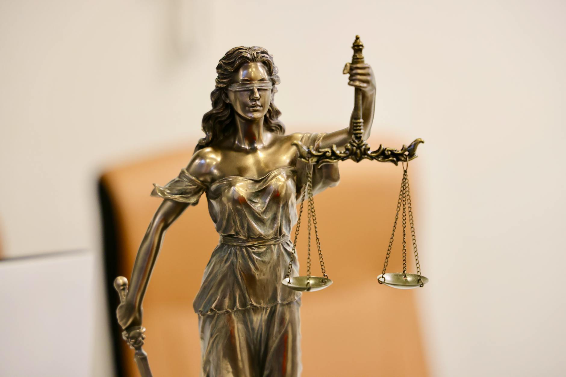 statue of lady justice with scales, begging consideration of wants vs needs and opportunities for peace via common ground during times of unrest