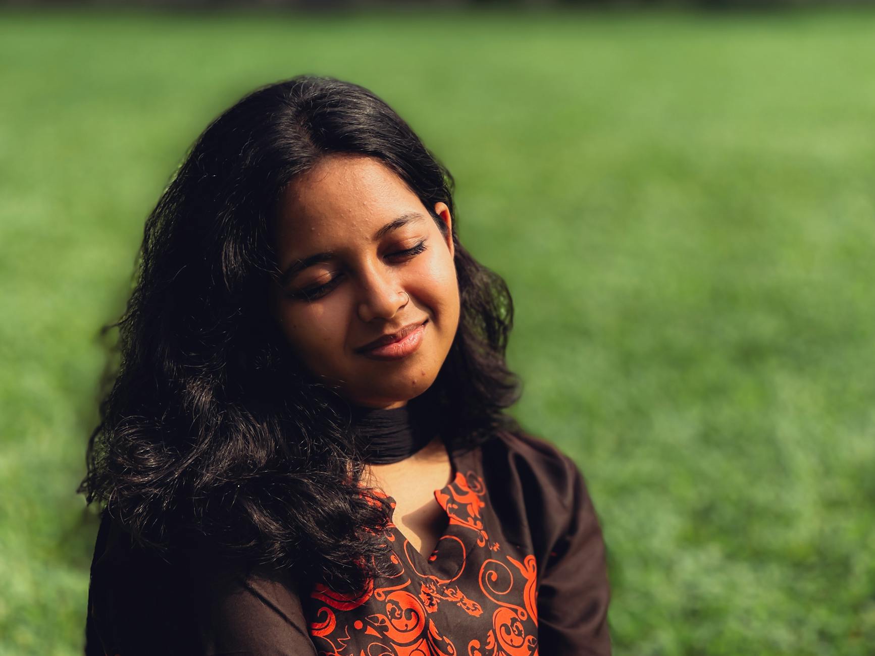 serene woman relaxing in sunlit meadow, exploring meditation style, personalized meditation, traditional meditation, mindfulness habits, and mind-body connection